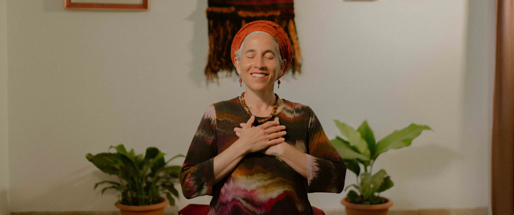 Chana Mason sitting in meditation with her hands at her heart