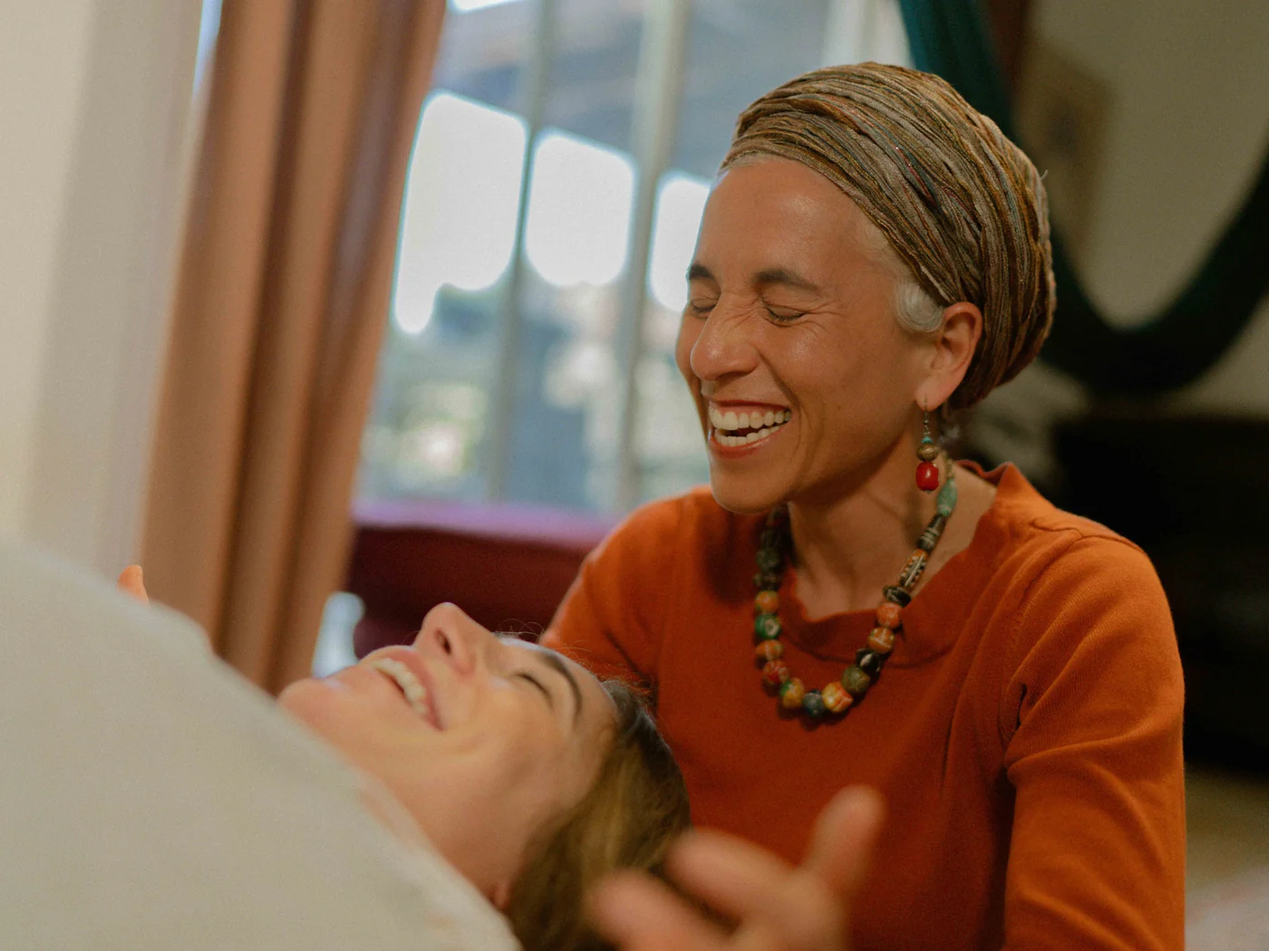 Chana Mason laughing with a client during a session